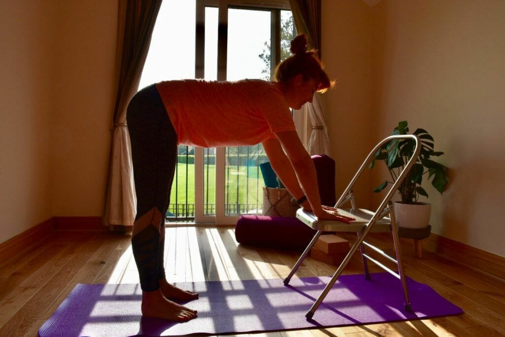 a woman is doing yoga on a purple mat.