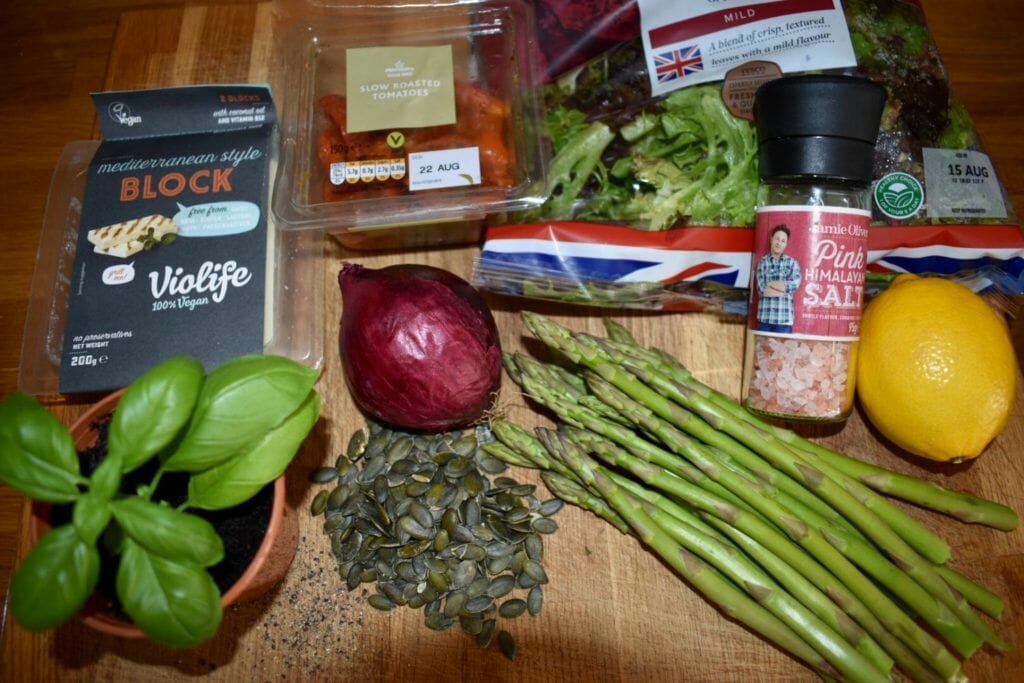 a wooden table topped with vegetables and spices.