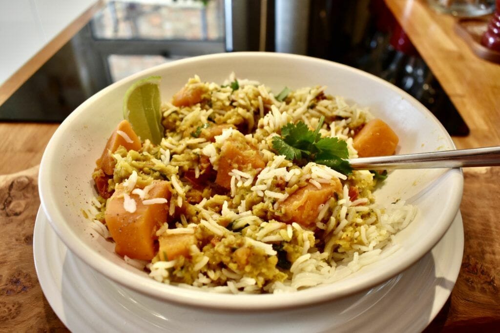a white bowl filled with rice and vegetables.