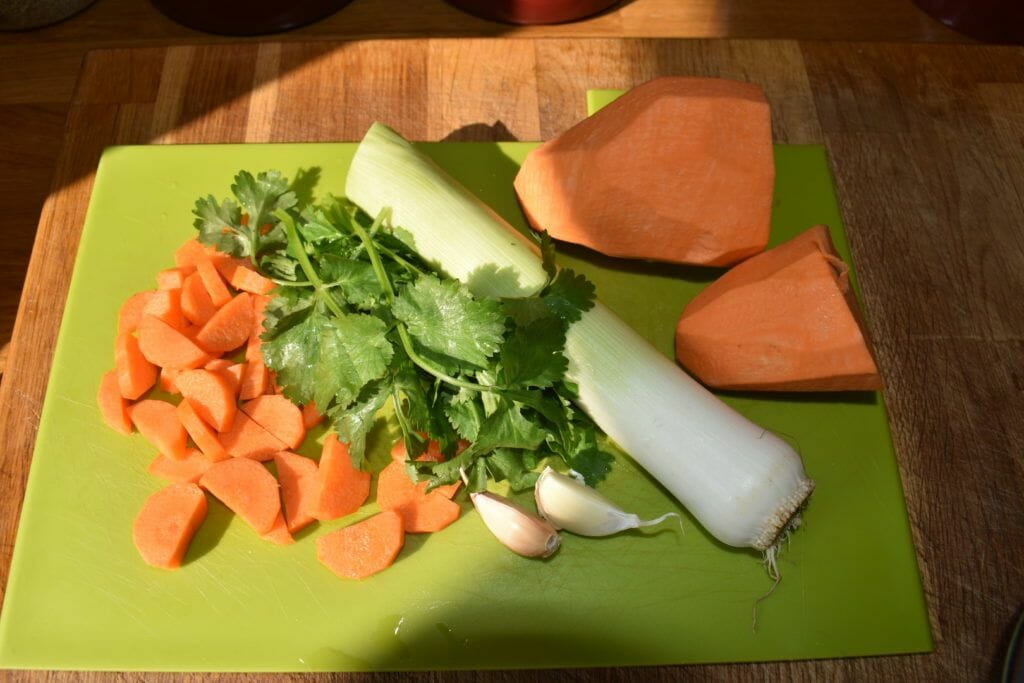 carrots, celery, and celery on a cutting board.