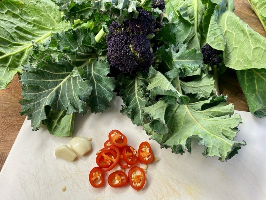 a cutting board topped with lettuce and tomatoes.