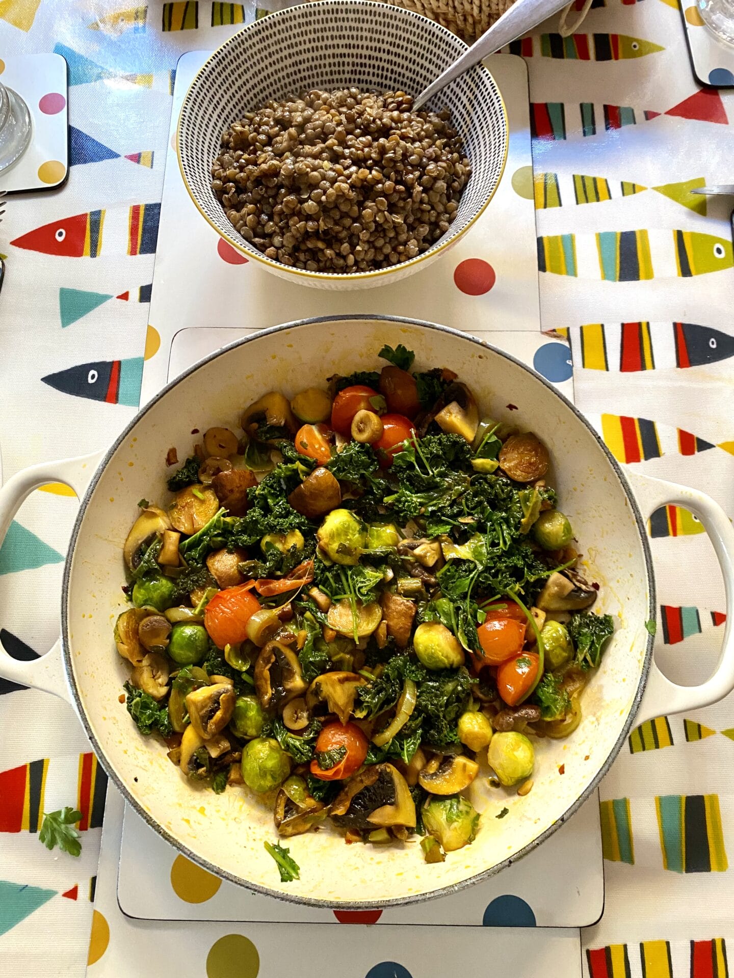 a bowl of vegetables and a bowl of lentils on a table.
