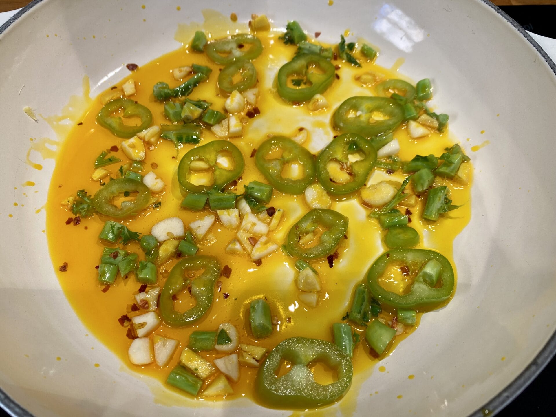 a white plate topped with green peppers and cheese.