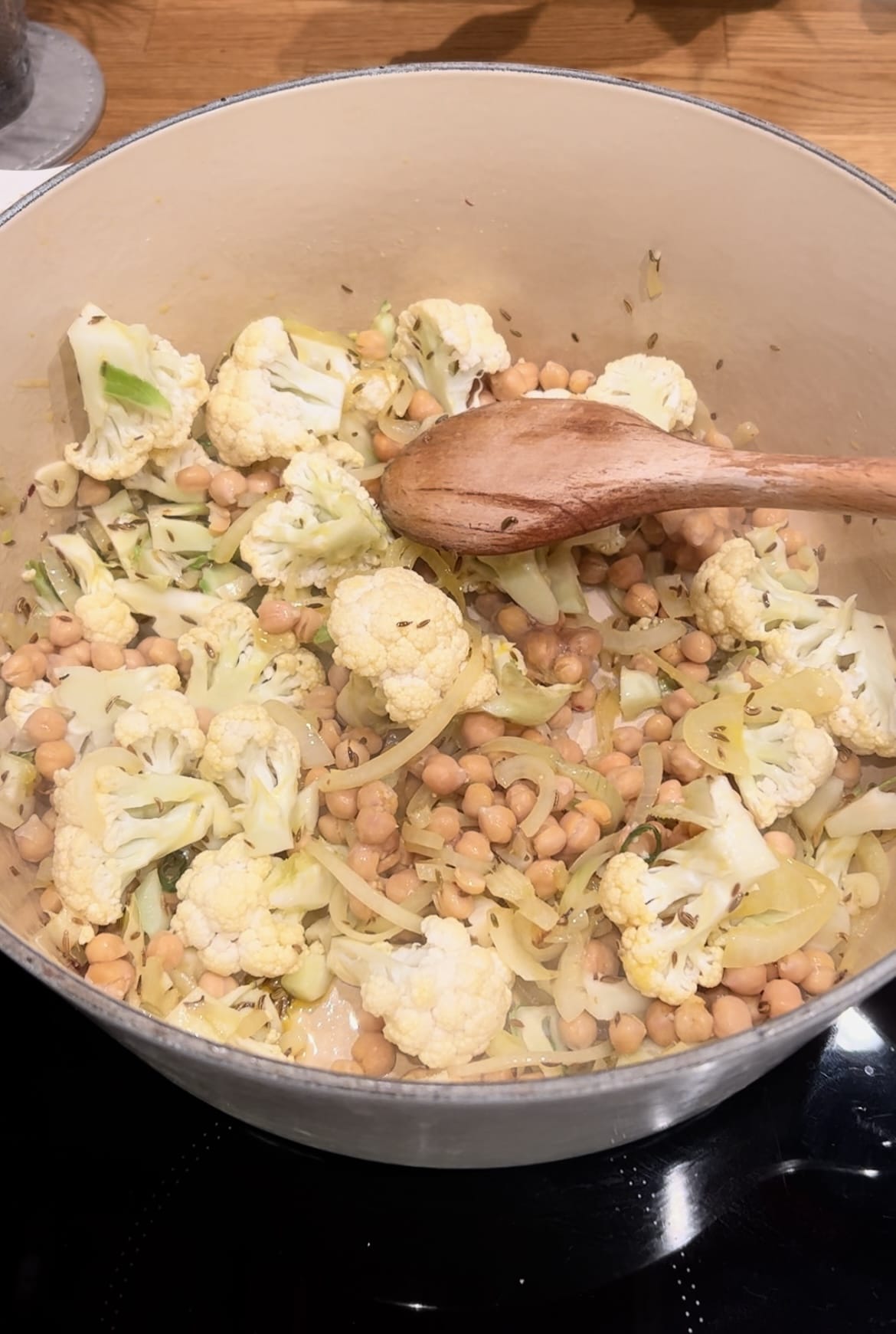 a wooden spoon in a pot of food.