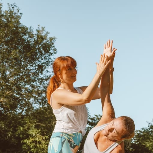 Julia and student practicing yoga in Bedford park