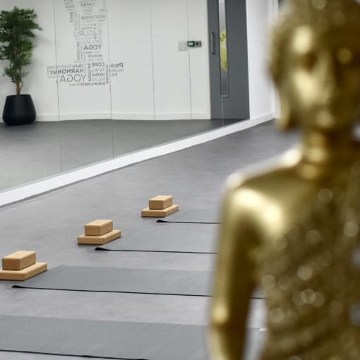 a golden statue sitting on top of a cement floor.