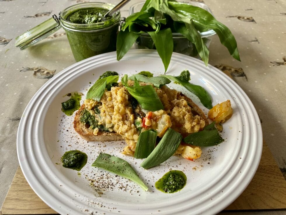a white plate topped with food next to a cup of green smoothie.