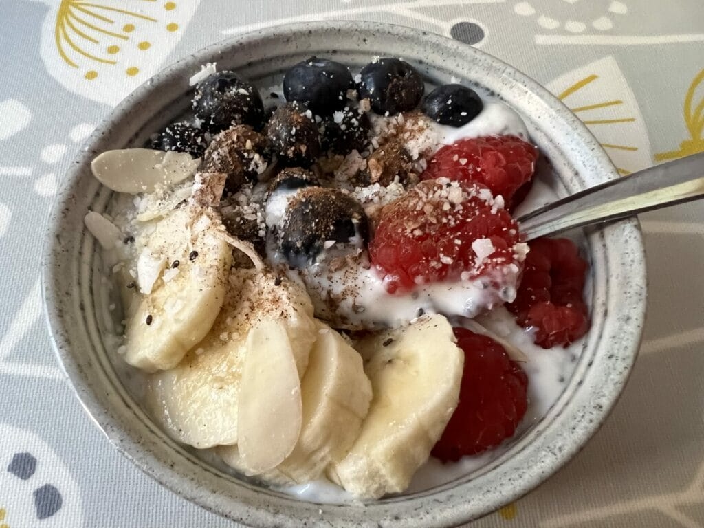 A Go To Yogi Breakfast bowl with yogurt, berries, and bananas.