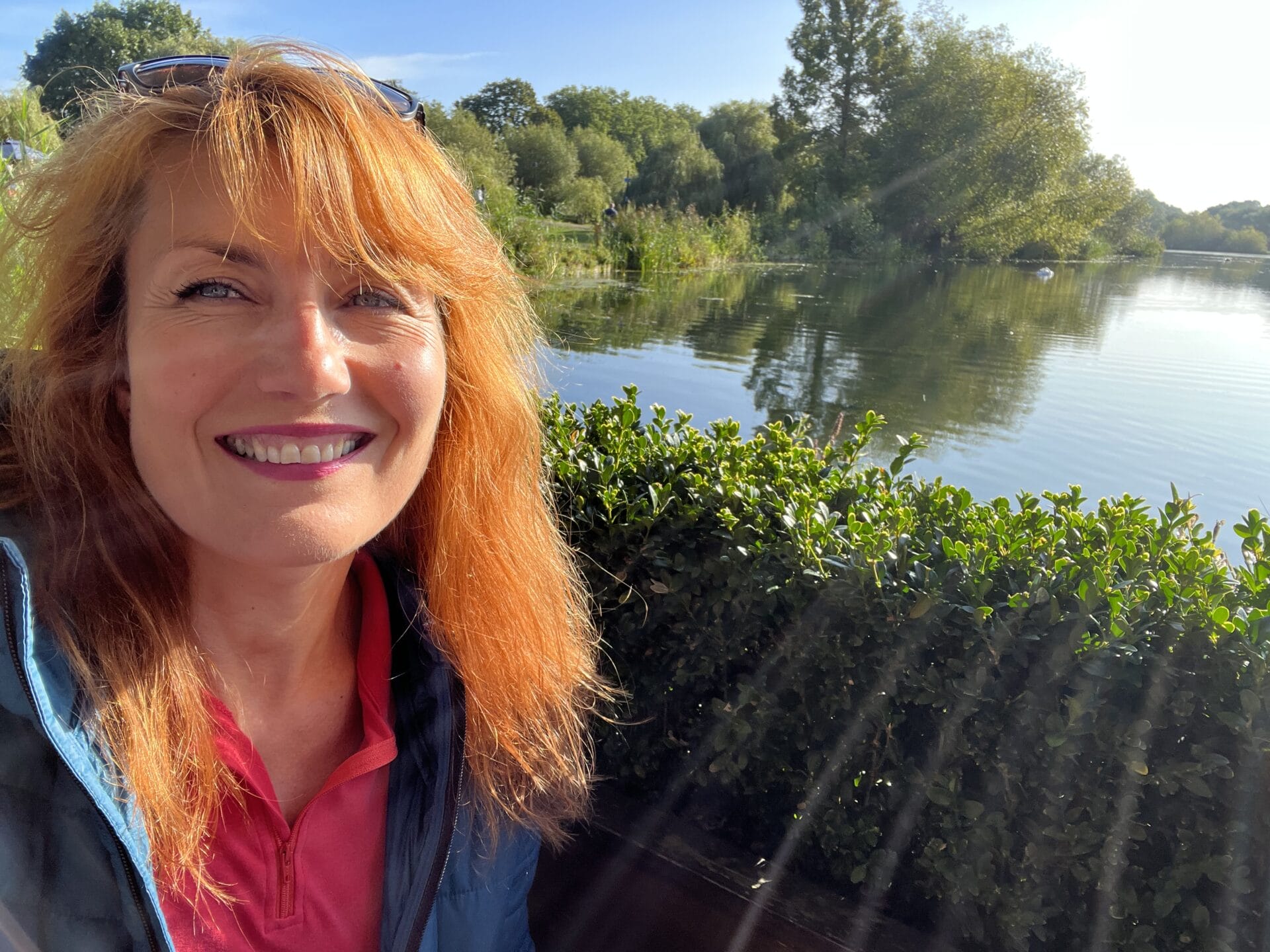A woman enjoying herself in front of a body of water. Julia enjoying herself in front of a body of water.